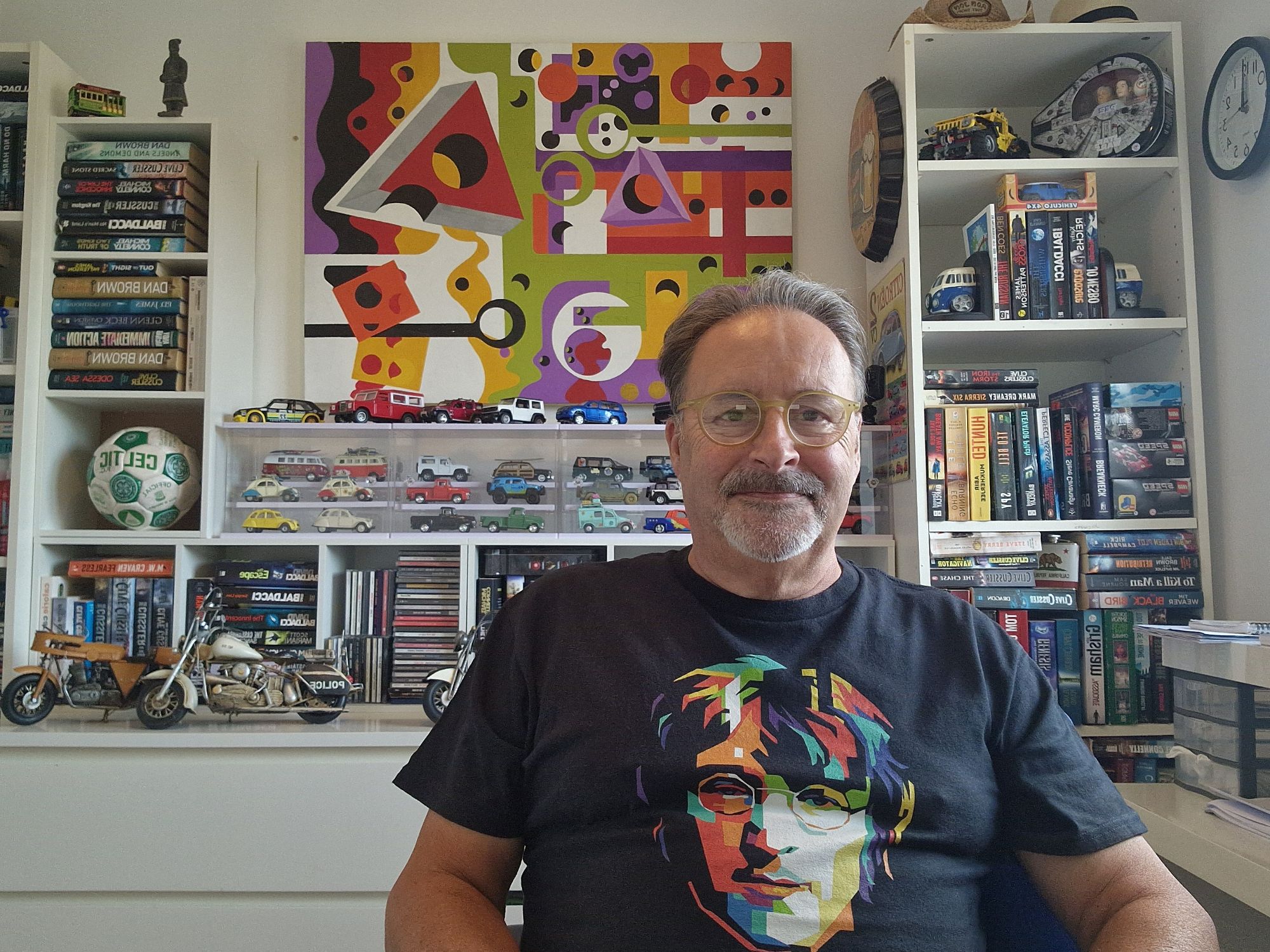 Craig J. Lemmon standing beside a bookshelf at home